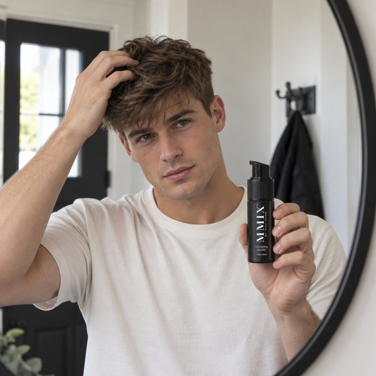 Man styling his hair holding MMIX Styling Powder